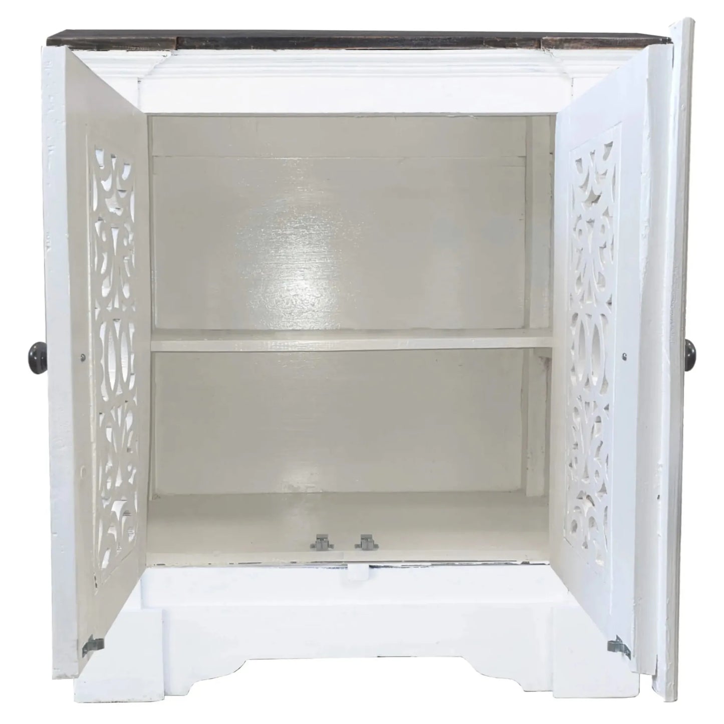 White cabinet with decorative cut-out design on a white background