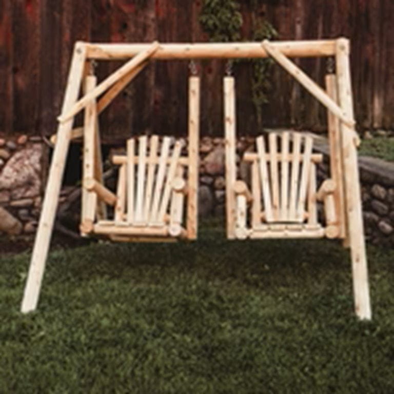 Wooden swing set with two seats on a grassy area.