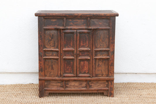 Vintage wooden cabinet with a distressed finish on a plain background