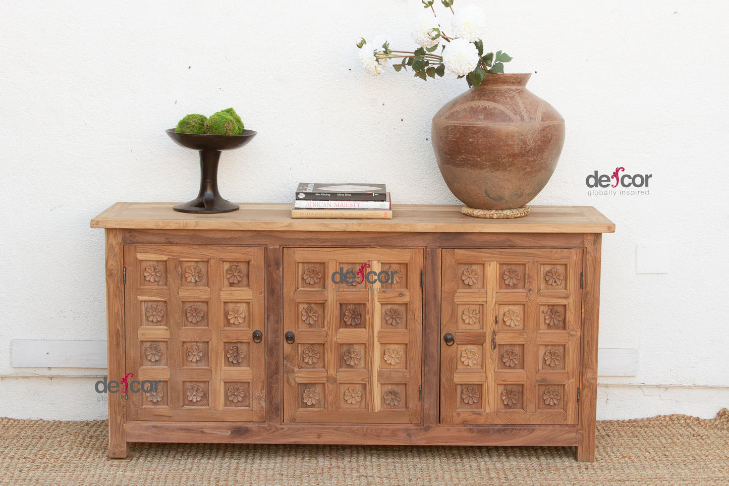 Wooden cabinet with decorative elements on a white wall background