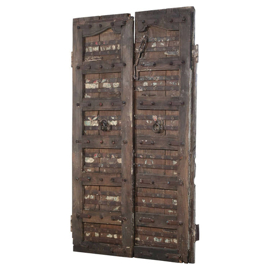 Pair of large wooden doors with metal reinforcements on a white background