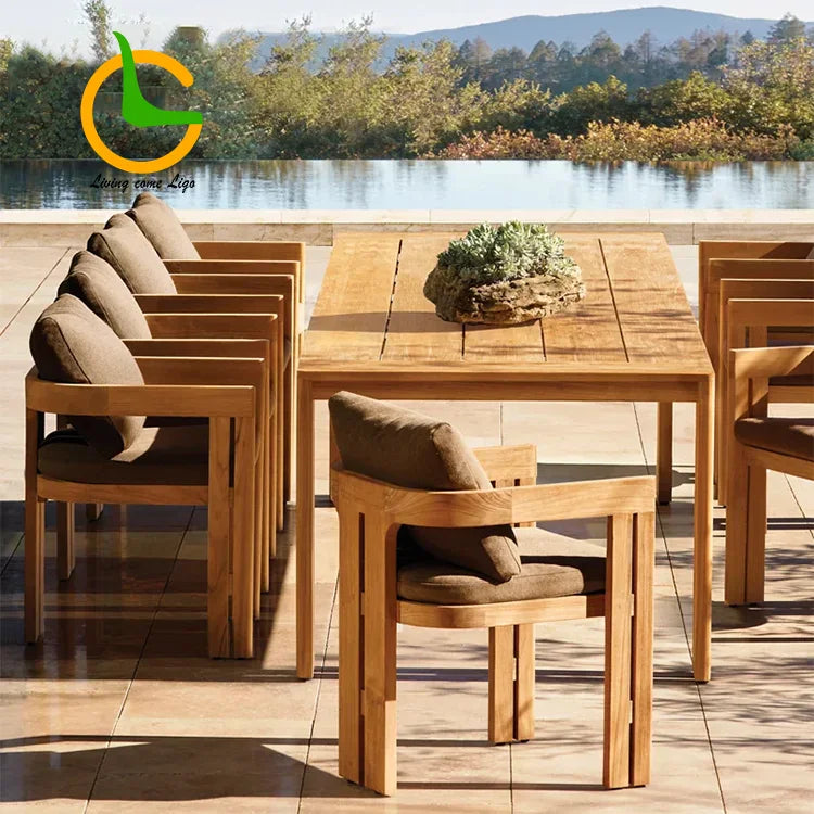 Wooden outdoor dining set with chairs and table by a body of water.