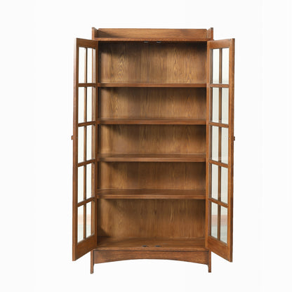 A mid-century modern wooden bookcase with two glass-paneled doors and five interior shelves, shown against a plain white background.