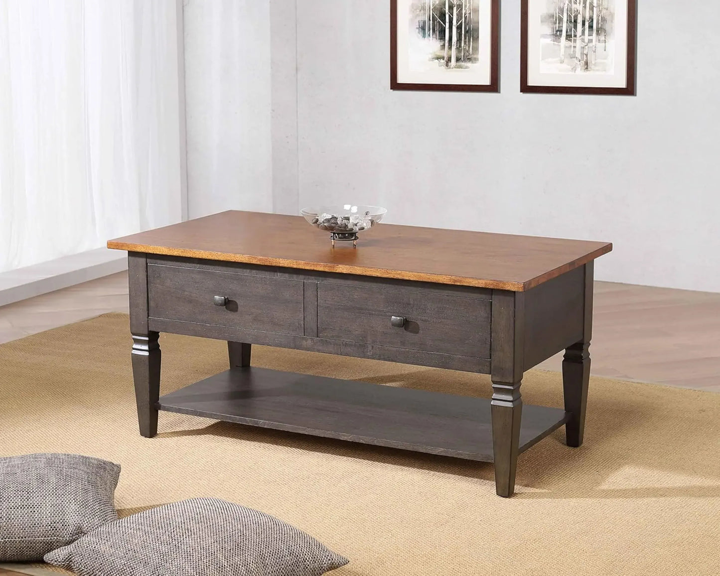 Two-toned wooden coffee table with gray base in a room setting.