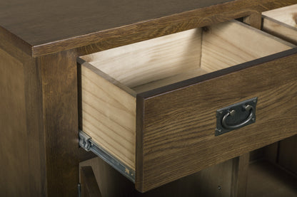 Close-up of a wooden drawer with the front panel pulled out slightly, showing a light natural wood interior, a dark metal pull handle, and metal drawer hardware on a wooden cabinet.