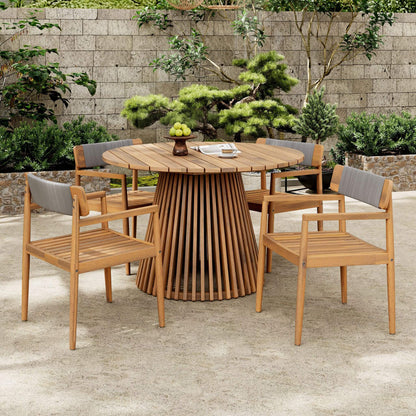 Wooden outdoor dining set with round table and chairs on a patio.