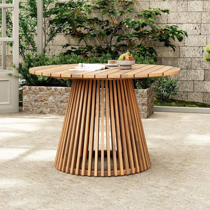 Wooden outdoor dining table with a slatted base on a patio