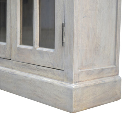 Close-up of a wooden cabinet with glass panels on a white background