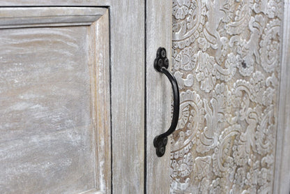 Wooden cabinet with decorative embossed pattern and black handle