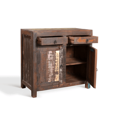A rustic dark brown wooden side cabinet with distressed patches, featuring two open drawers, a paneled front door, and an open side cabinet door showing shelves inside, photographed on a white studio background.