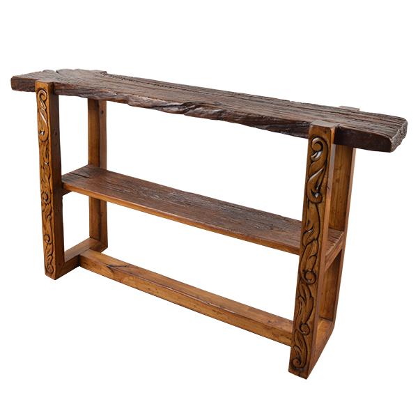 A rustic wooden console table with a thick, live-edge top, a middle shelf, and carved decorative details on the legs, shown against a plain white background.