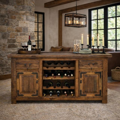 A rustic wooden wine cooler and bar cart with a built-in wine rack, shown in a styled home interior with stone walls, candles, and wine glasses.