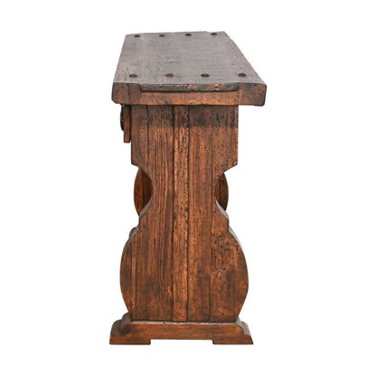 A rustic brown wooden console table with a thick rectangular top, distressed finish, and decorative carved legs, shown against a plain white background.