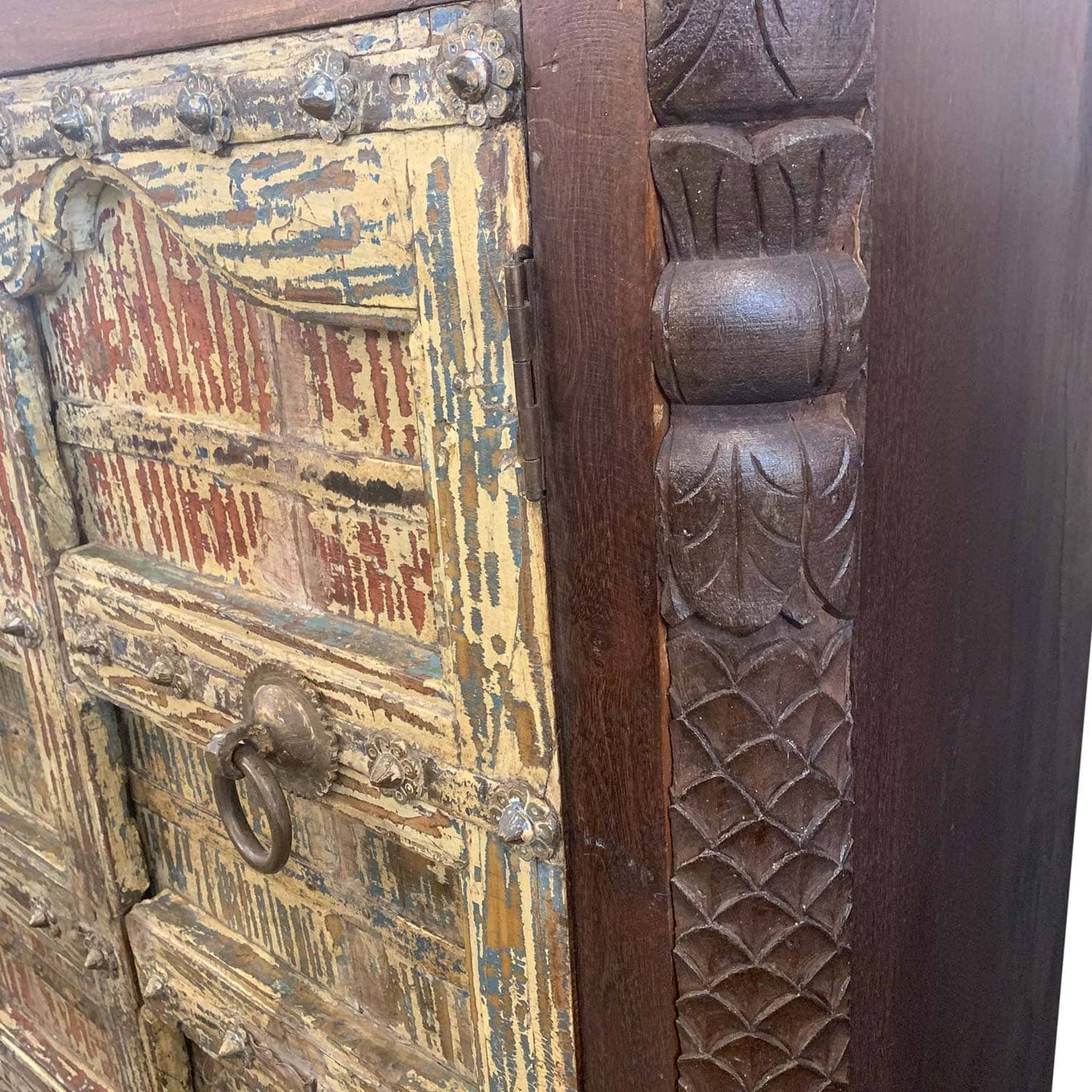 Close-up of an ornate wooden door with intricate carvings and a keyhole.
