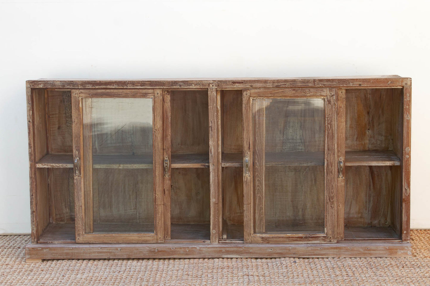 Wooden cabinet with glass doors on a white background
