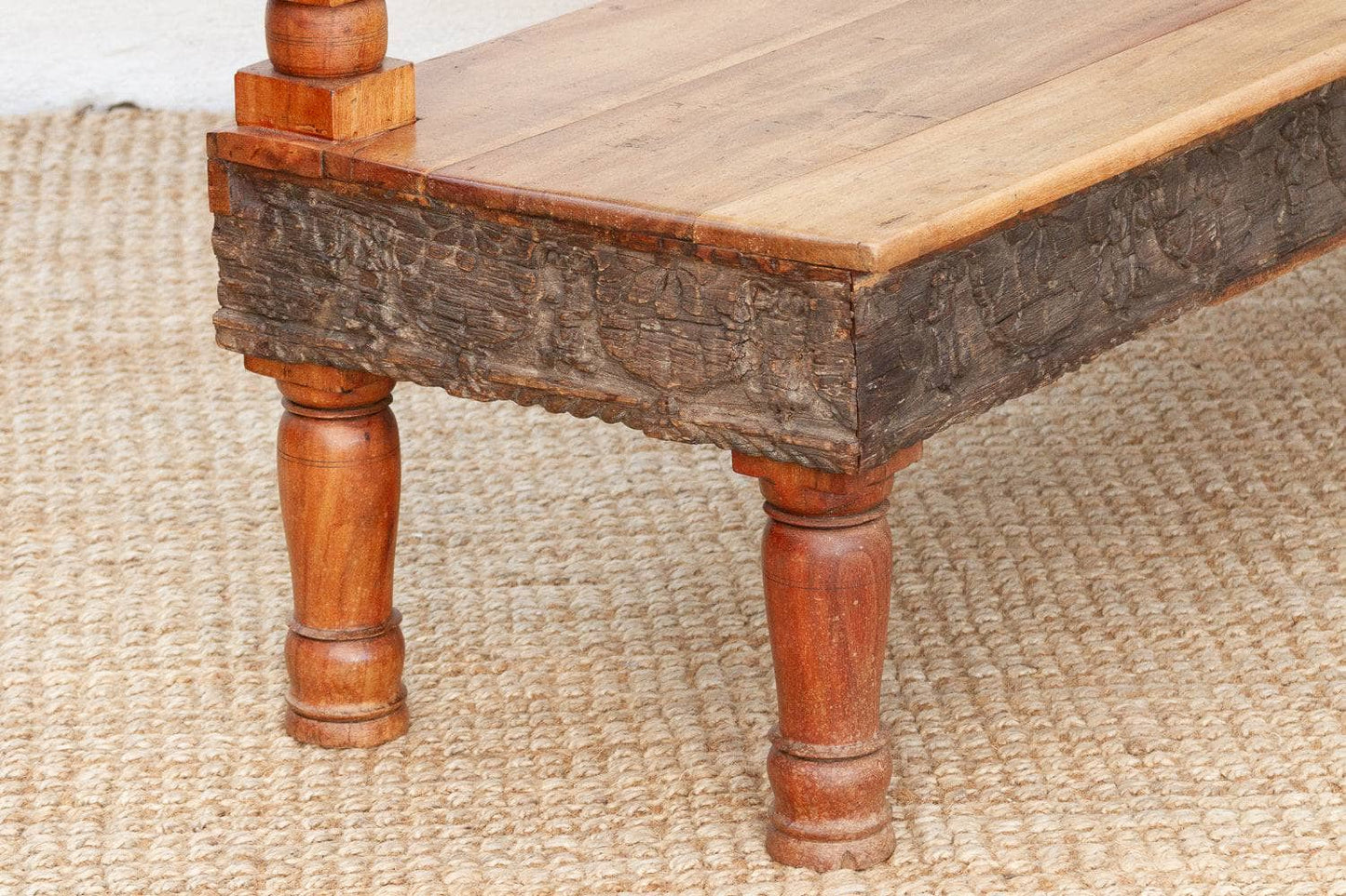 Wooden table with rustic legs on a textured surface