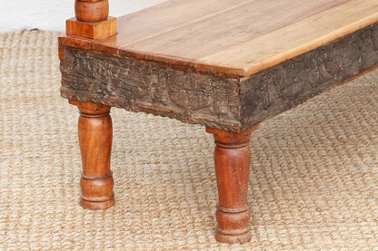 Wooden table with rustic legs on a textured surface