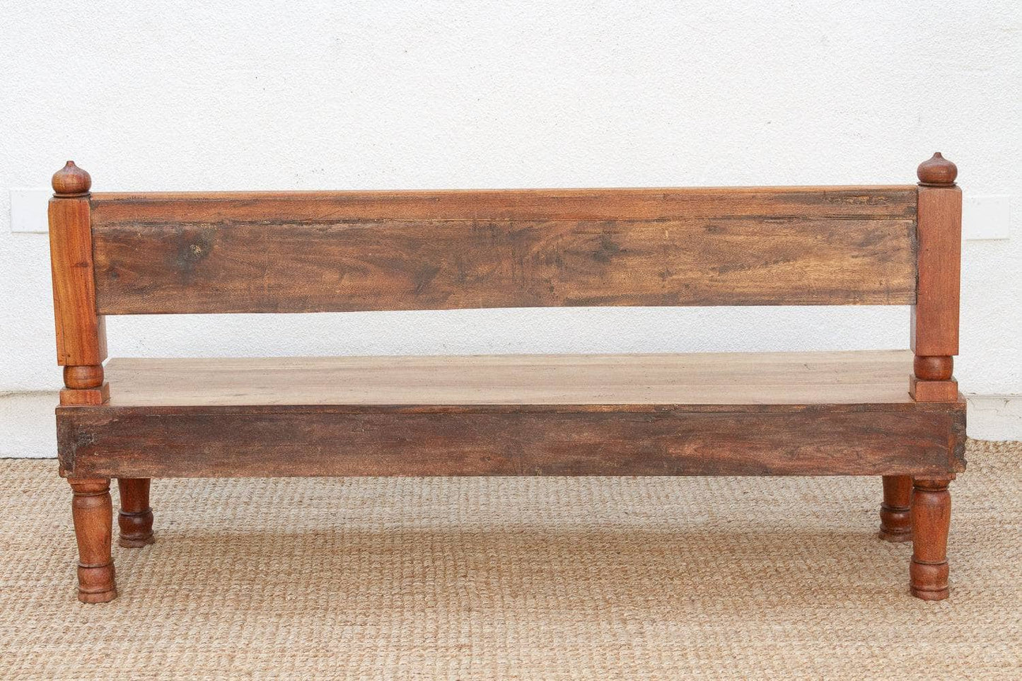 Wooden bench with turned legs on a plain background