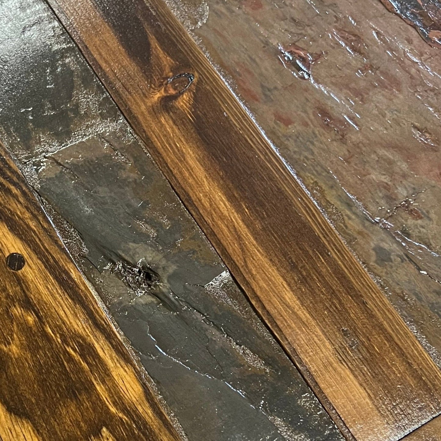 Close-up of a wooden floor with a focus on texture and color variation.