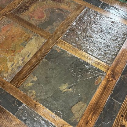 Close-up of a stone floor with wooden border