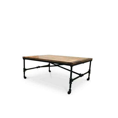 Industrial mango wood coffee table with iron legs and wheels in modern rustic living room