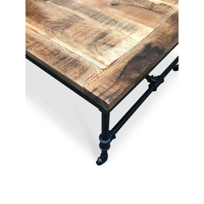 Artisan mango wood coffee table with welded steel frame and structural cross bracing on casters