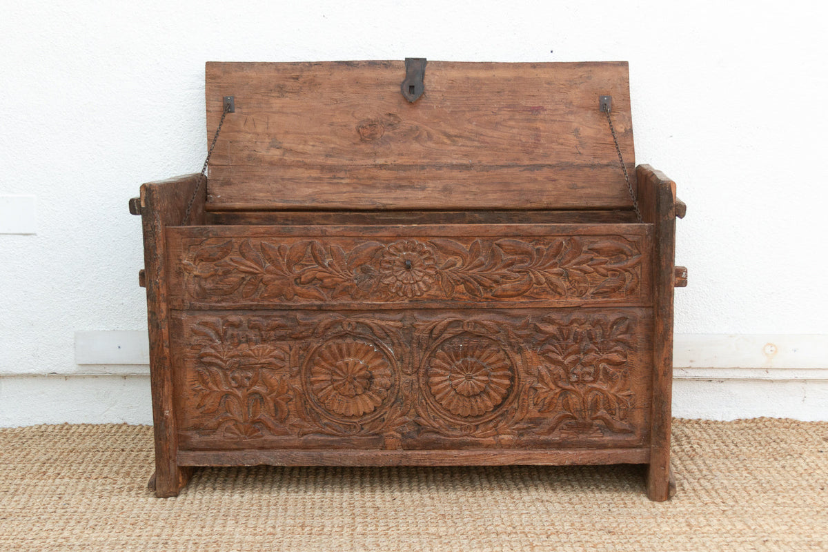 Wooden chest with intricate carvings on a white background