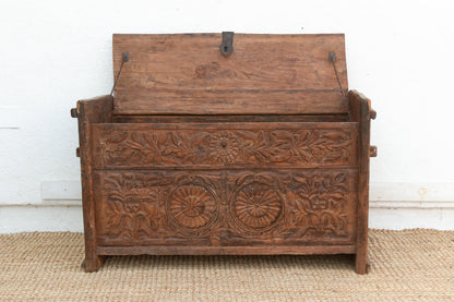 Wooden chest with intricate carvings on a white background