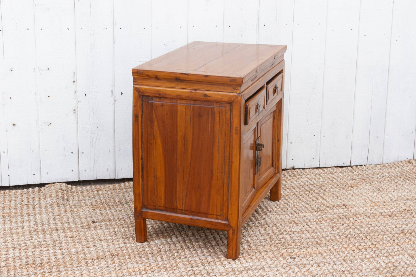 Wooden cabinet with a white wooden panel background