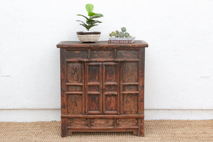 Wooden cabinet with decorative items on a white background