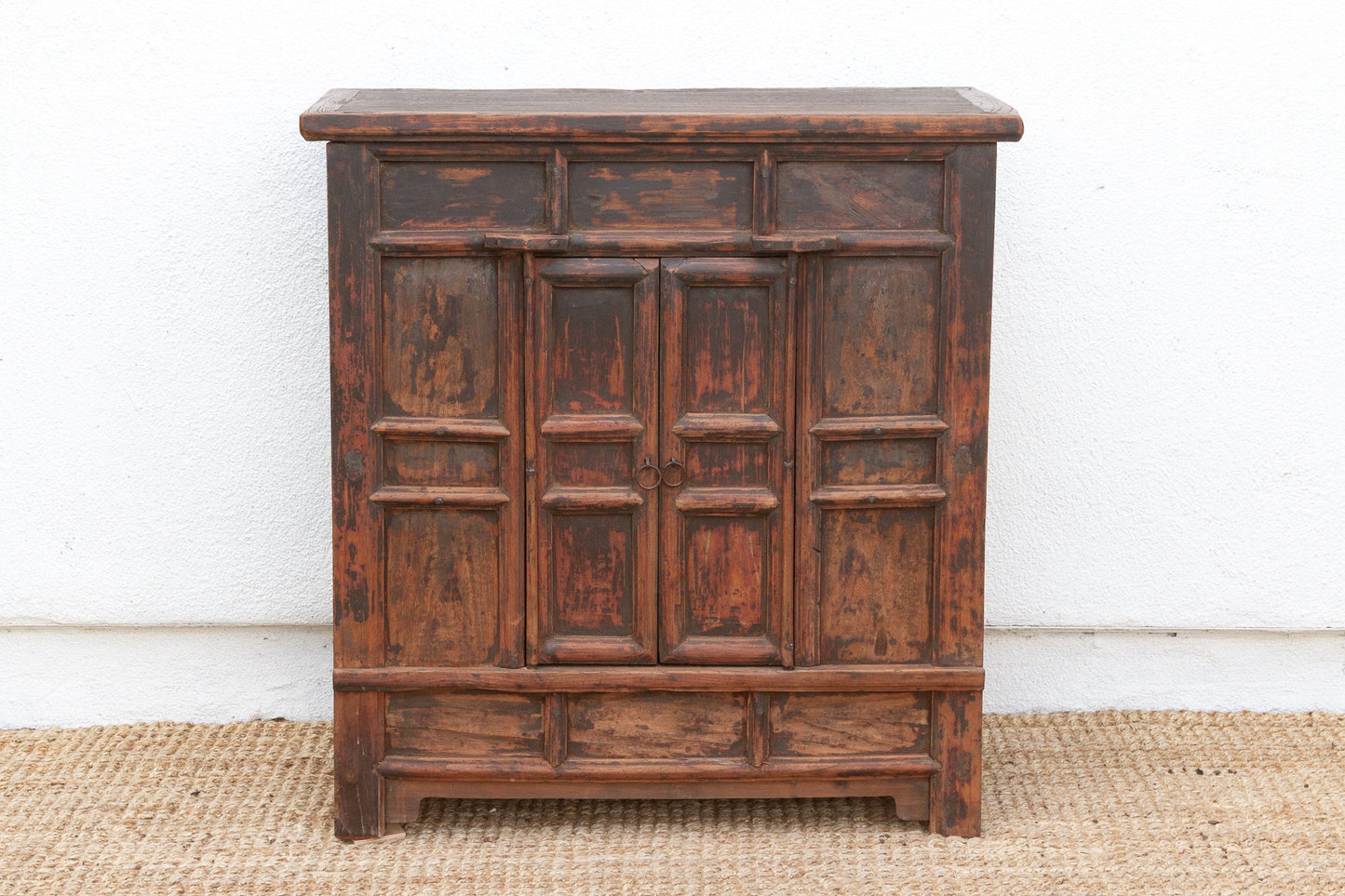 Vintage wooden cabinet with a distressed finish on a plain background