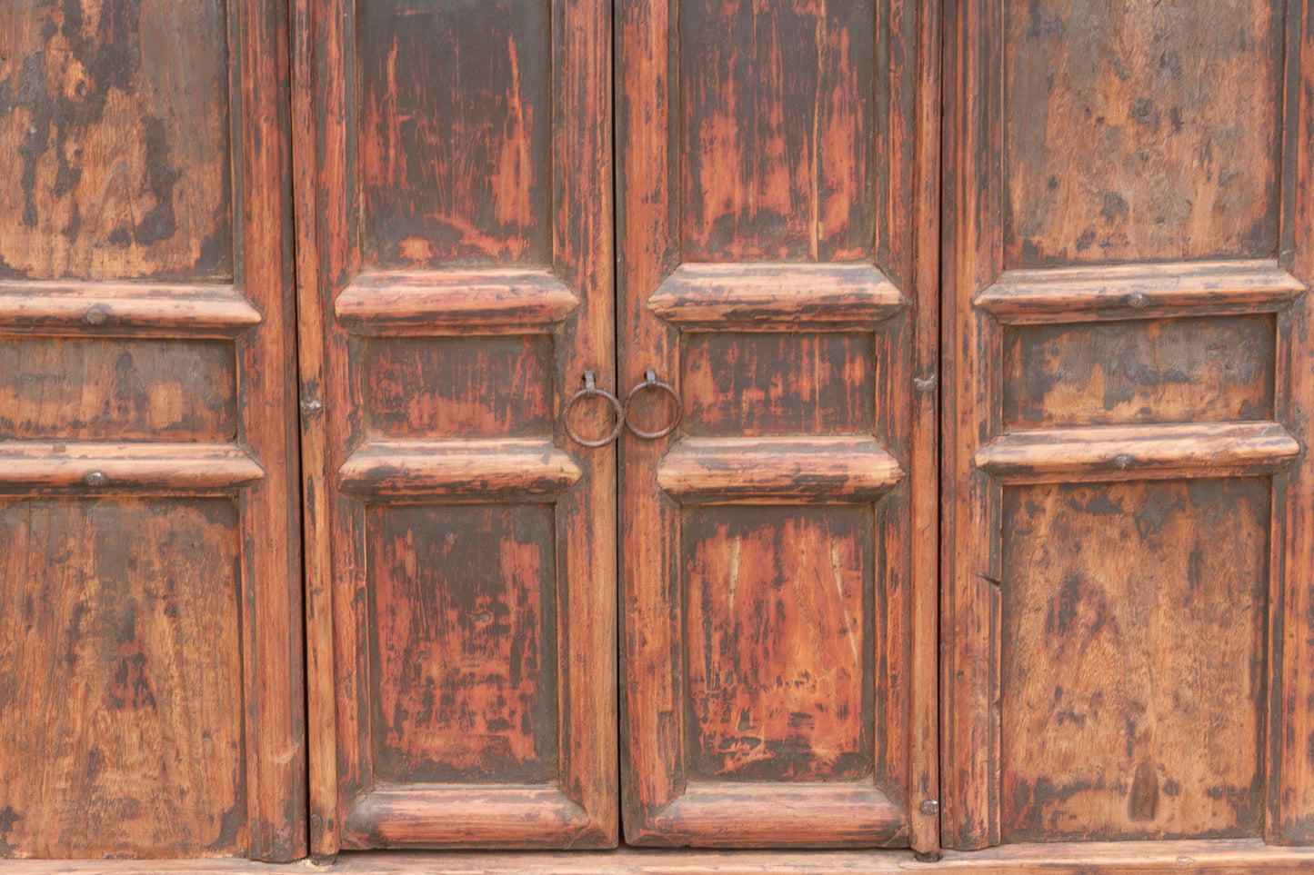 Close-up of a weathered wooden door with a handle
