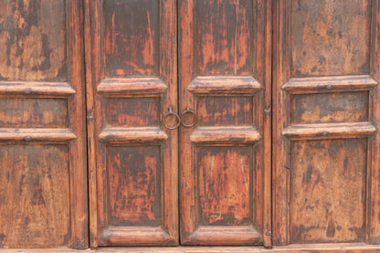 Close-up of a weathered wooden door with a handle