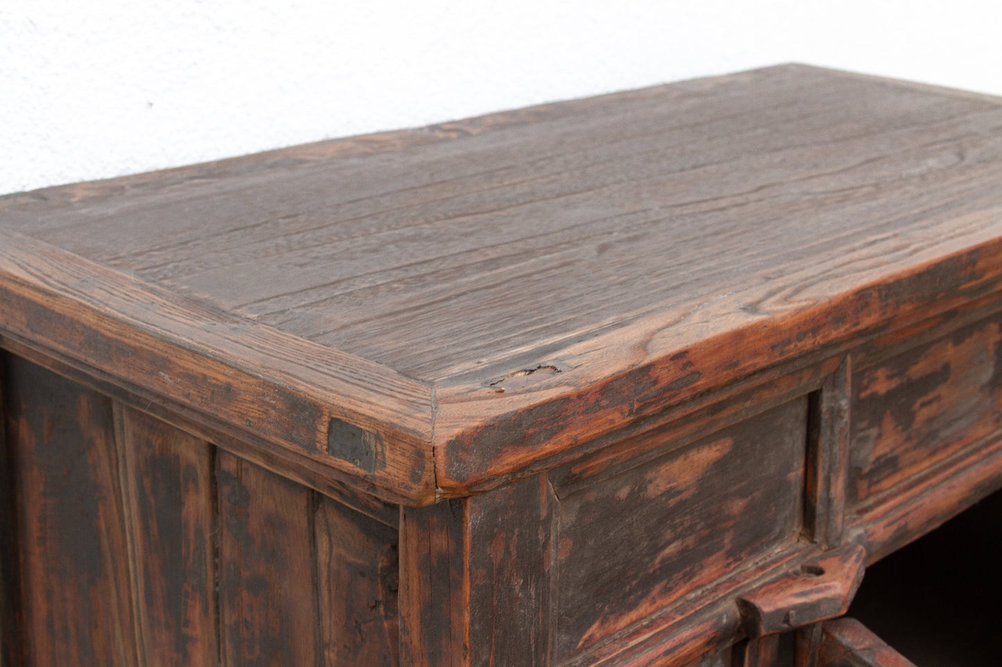 Vintage wooden desk with a worn surface on a white background