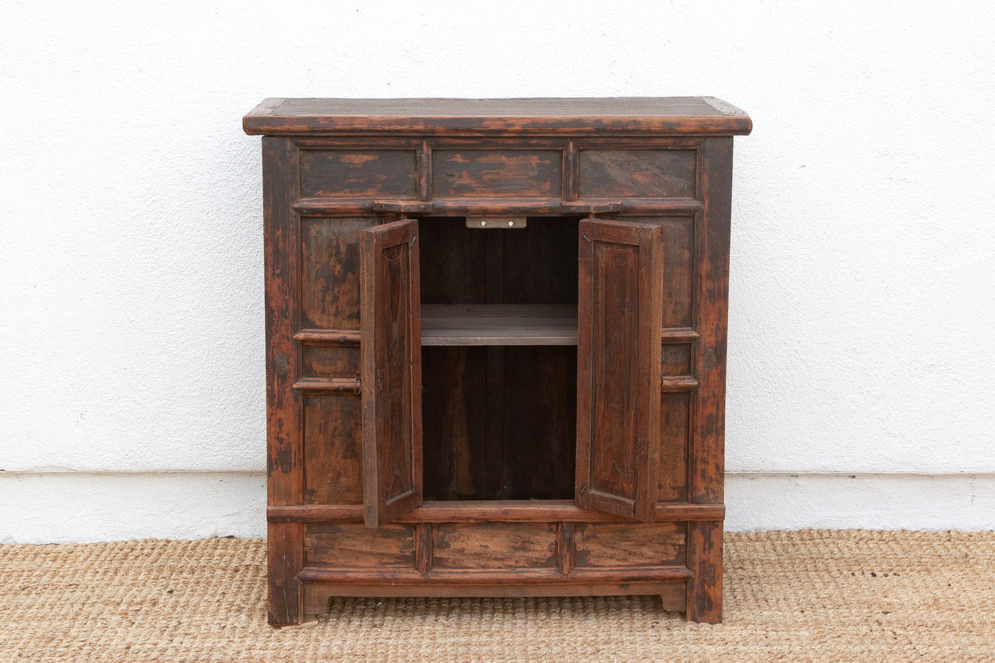 Wooden cabinet with open doors on a white background