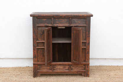 Wooden cabinet with open doors on a white background