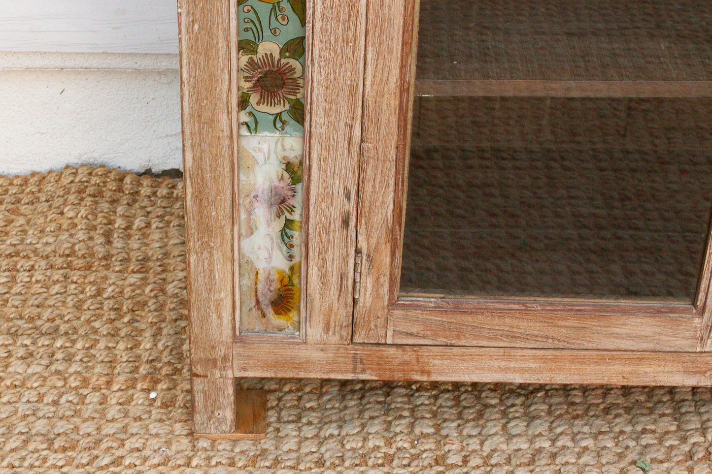 Vintage reverse glass painted cabinet with ornate decorative artwork