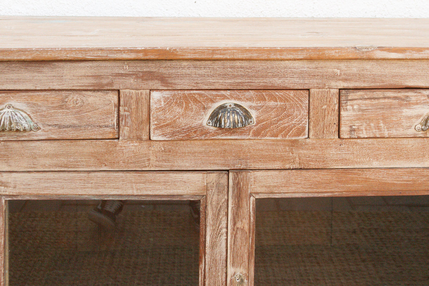 Close-up of reverse glass painting detail on antique buffet cabinet