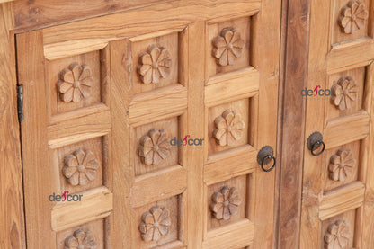 Wooden cabinet with floral carvings and metal handles, brand 'delicor' visible.