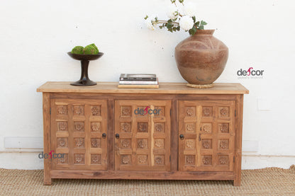 Wooden cabinet with decorative elements on a white wall background