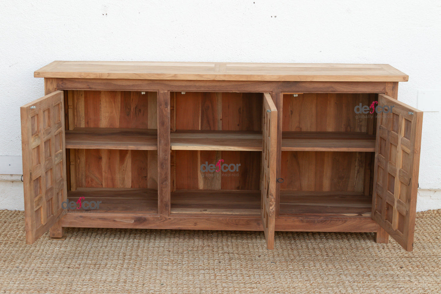 Wooden sideboard with open doors on a textured surface