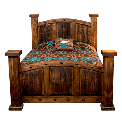 A rustic dark brown wooden bed frame with a matching headboard and footboard, styled with a turquoise and brown patterned comforter and a decorative accent pillow, isolated on a white background.