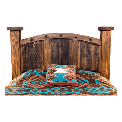 A rustic wooden bed frame with a curved slatted headboard and matching footboard, styled with a brown, turquoise, and beige southwestern patterned comforter and a matching accent pillow on a white background.