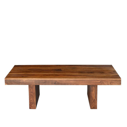 A rectangular wooden coffee table with a thick live-edge top and two blocky legs, shown against a plain white background.
