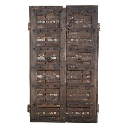 Large wooden door with metal reinforcements on a white background