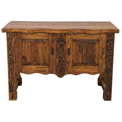 Carved rustic wood console in a cozy cabin entryway.