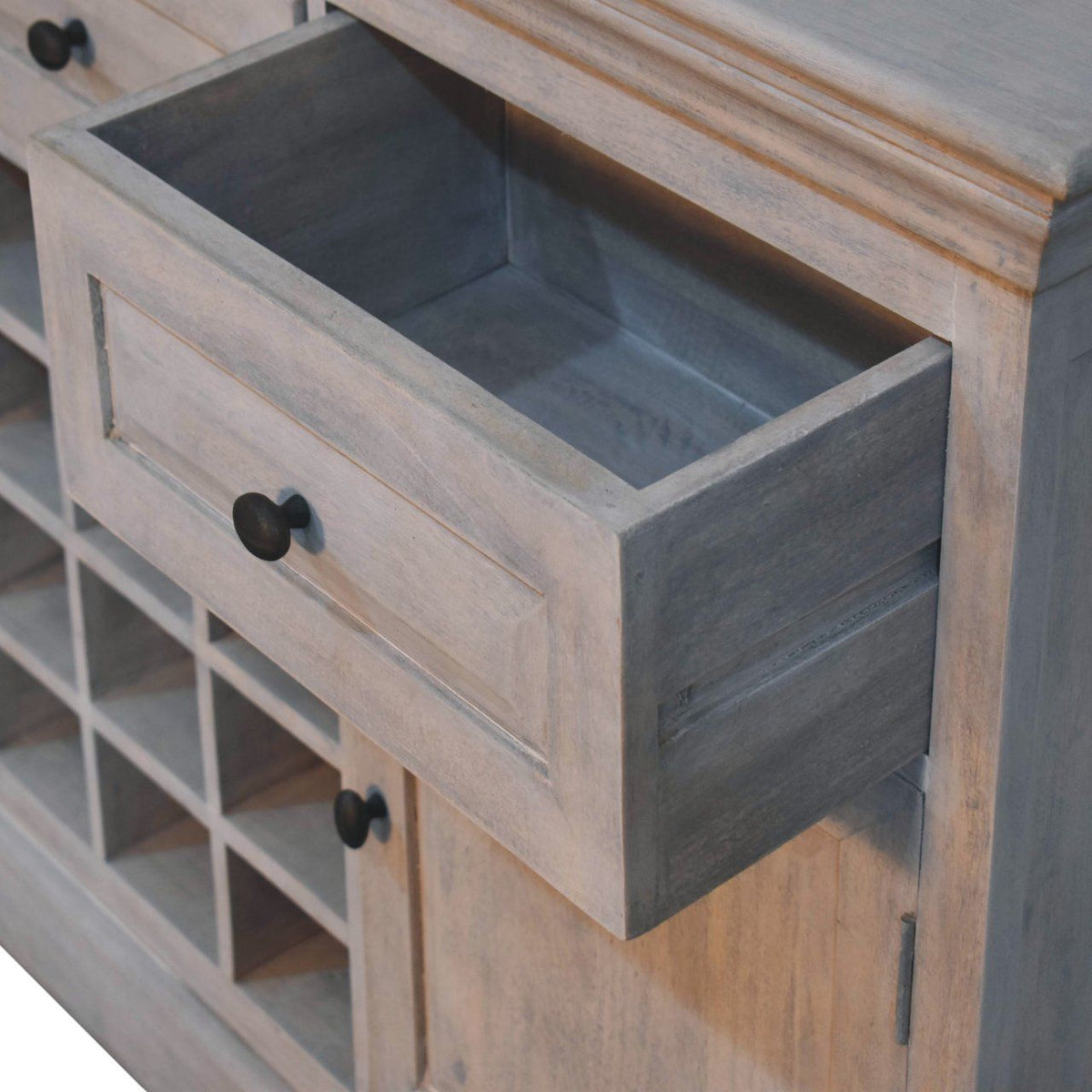 Wooden cabinet with a large drawer and wine rack.